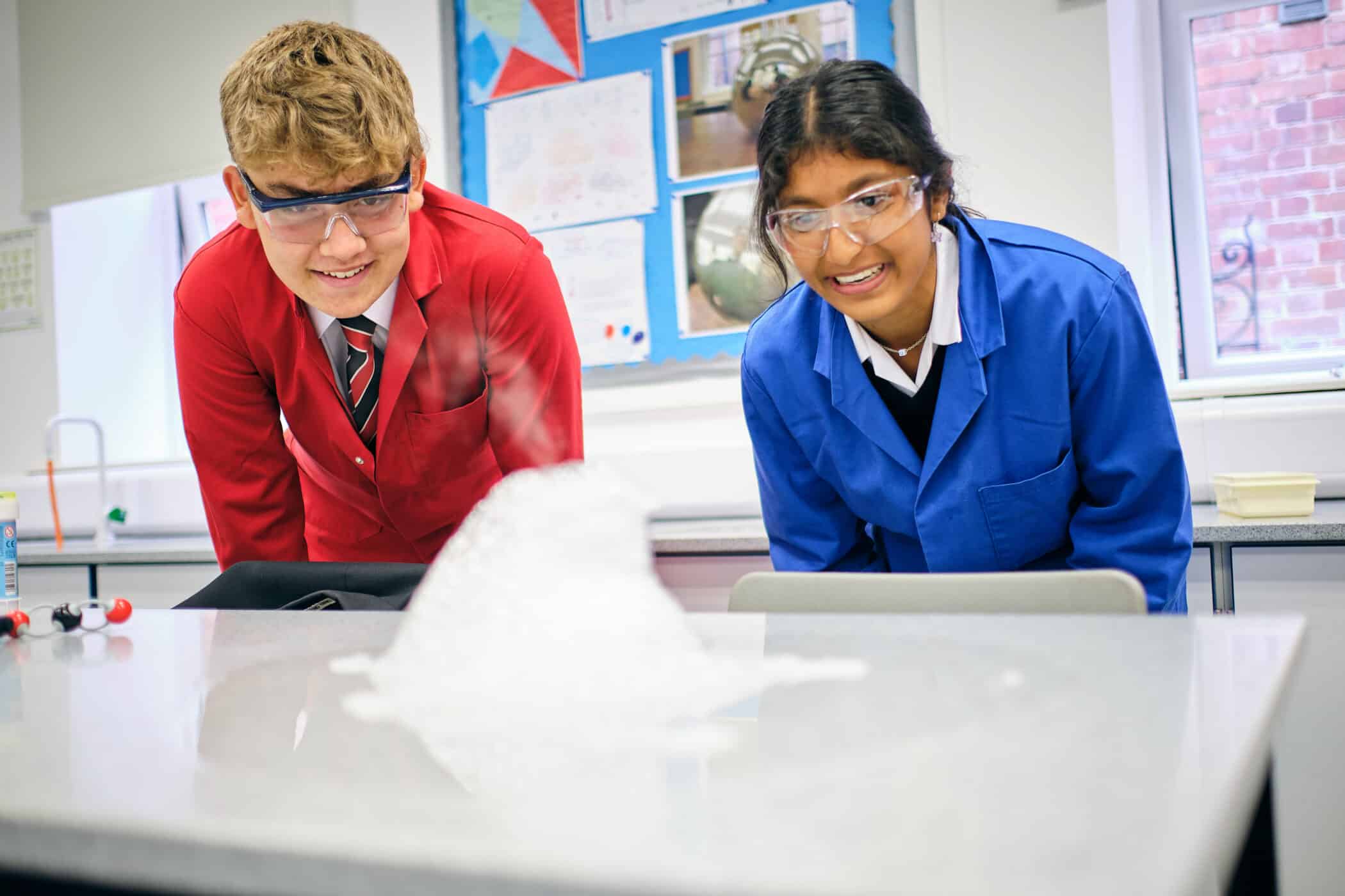 Boy and girl taking part in science experiment