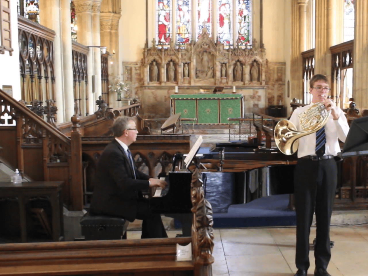 Oakham School student playing the horn accompanied on piano