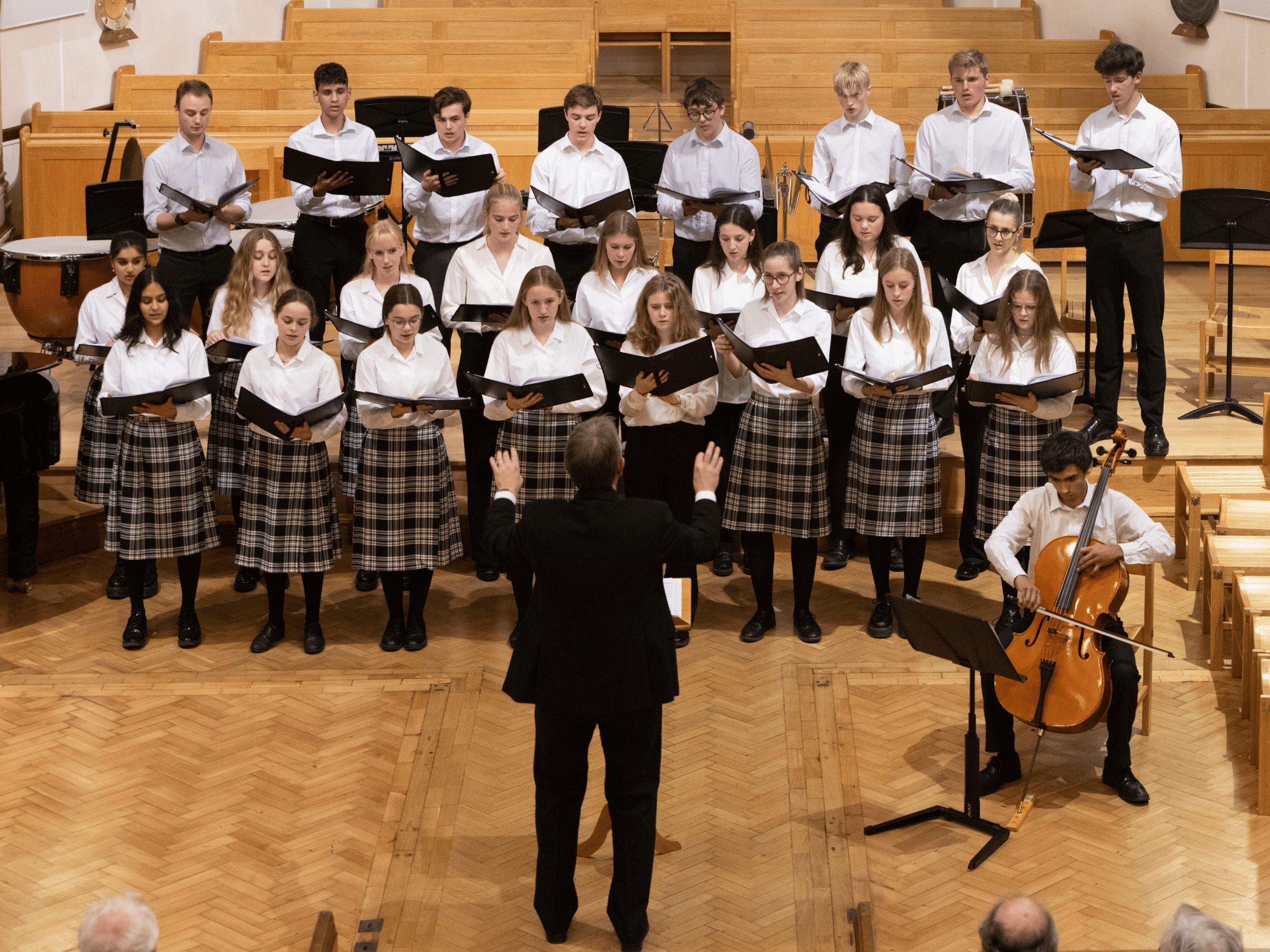 Chamber choir sing with cello accompaniment in concert