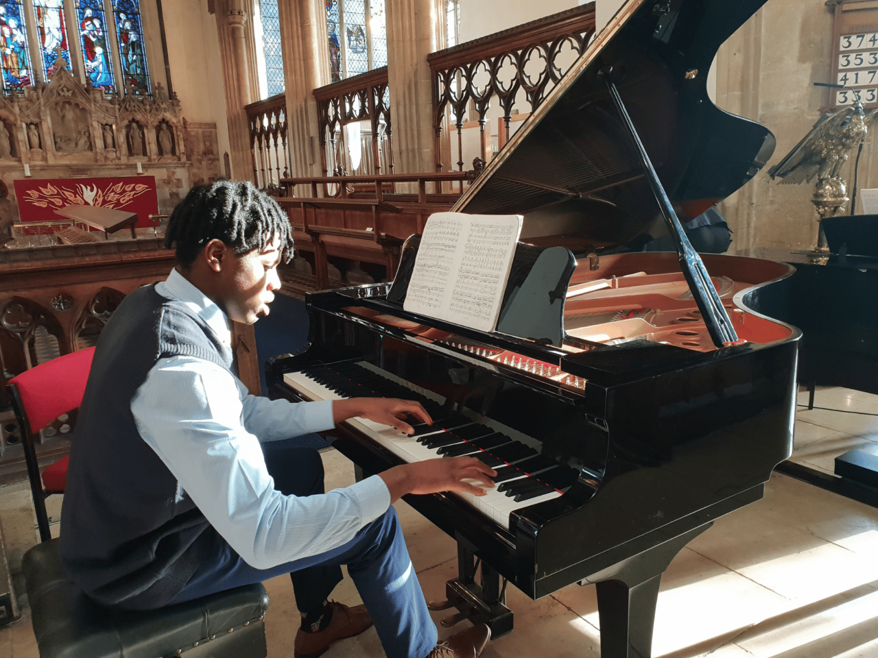 Student plays the piano in concert