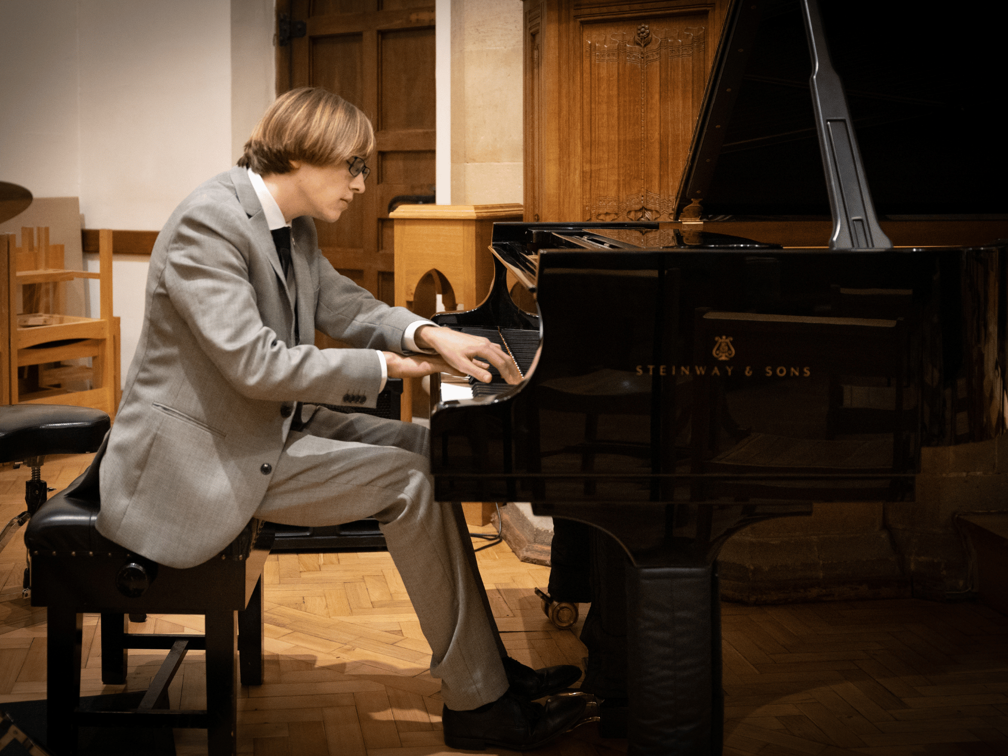 Student plays solo on grand piano