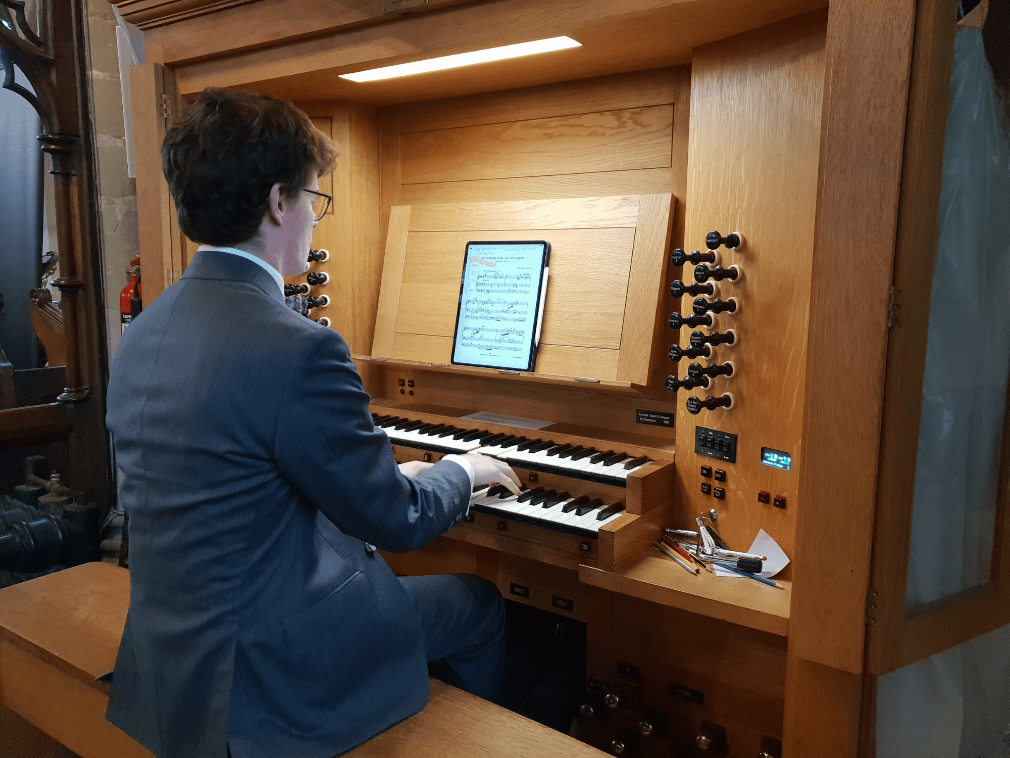 Close-up of teacher playing organ in church