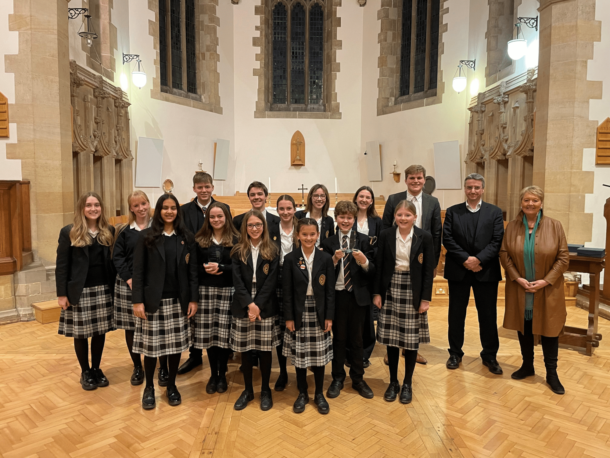 The 14 students who performed in the singing competition final, with the two adjudicators