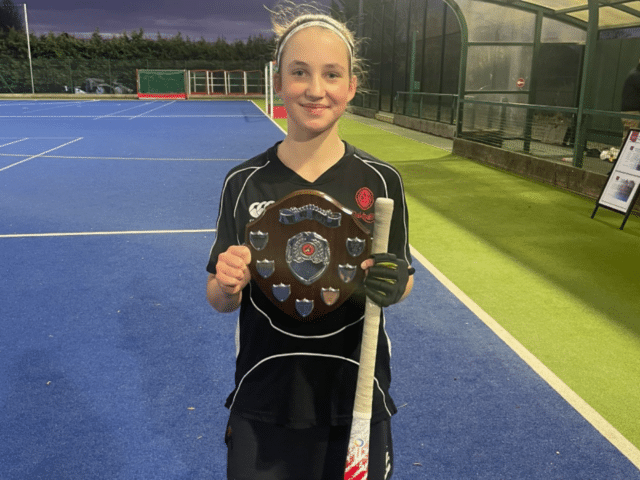 Hockey player holding trophy