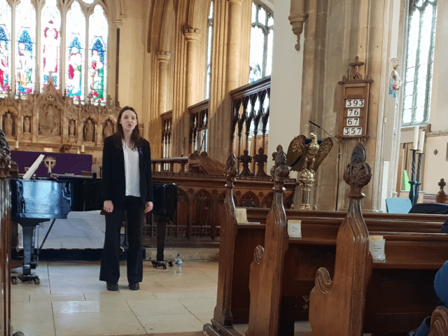 Student sings in a church in concert