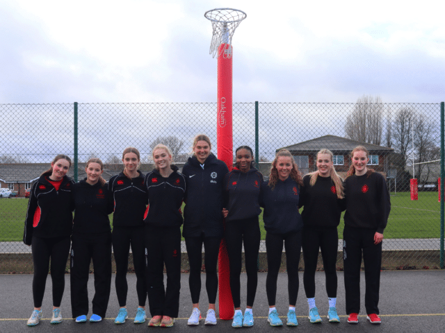 Netball players standing on court
