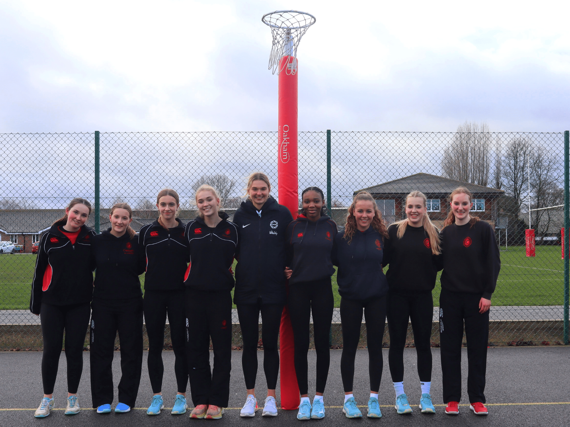 Netball players standing on court