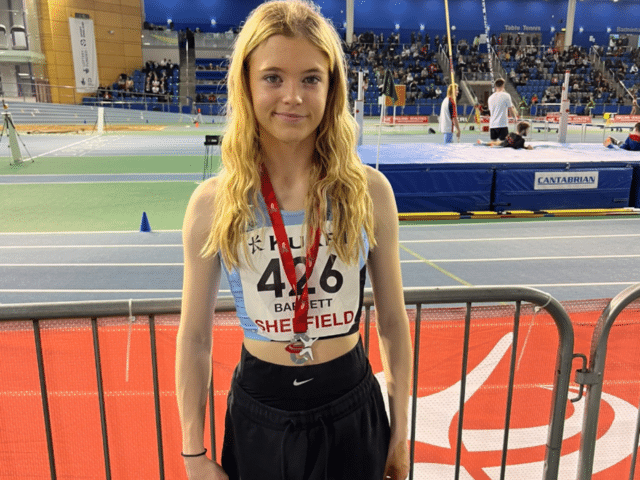 Sofia standing with silver medal around neck