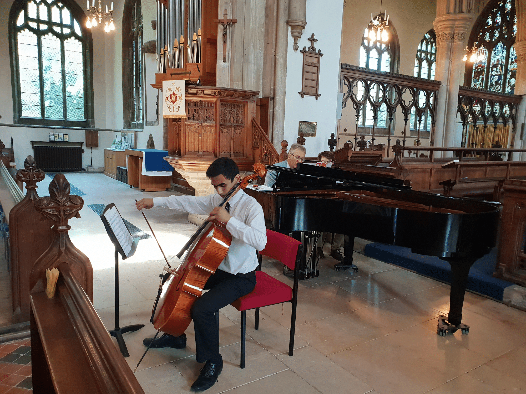 Student plays the cello in school recital in church