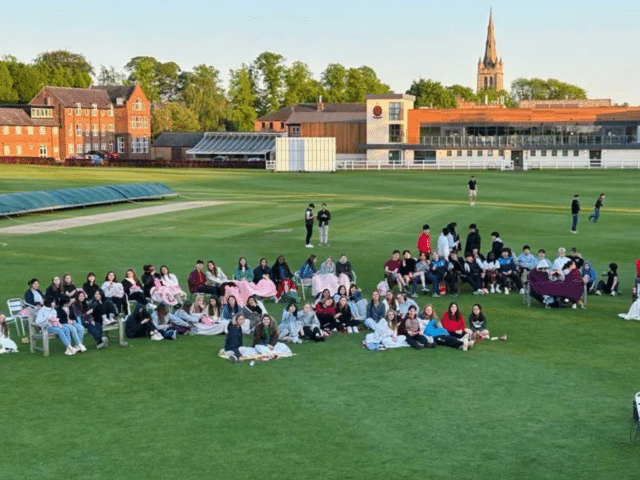 Pupils watching film at outdoor cinema