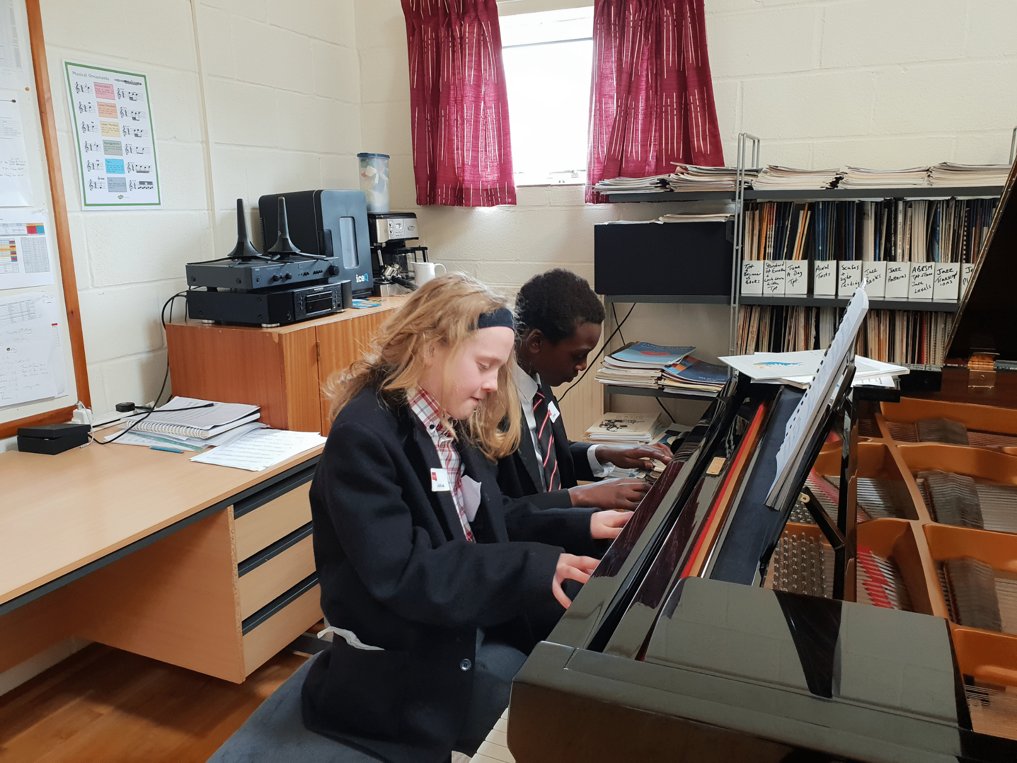 students play piano duet