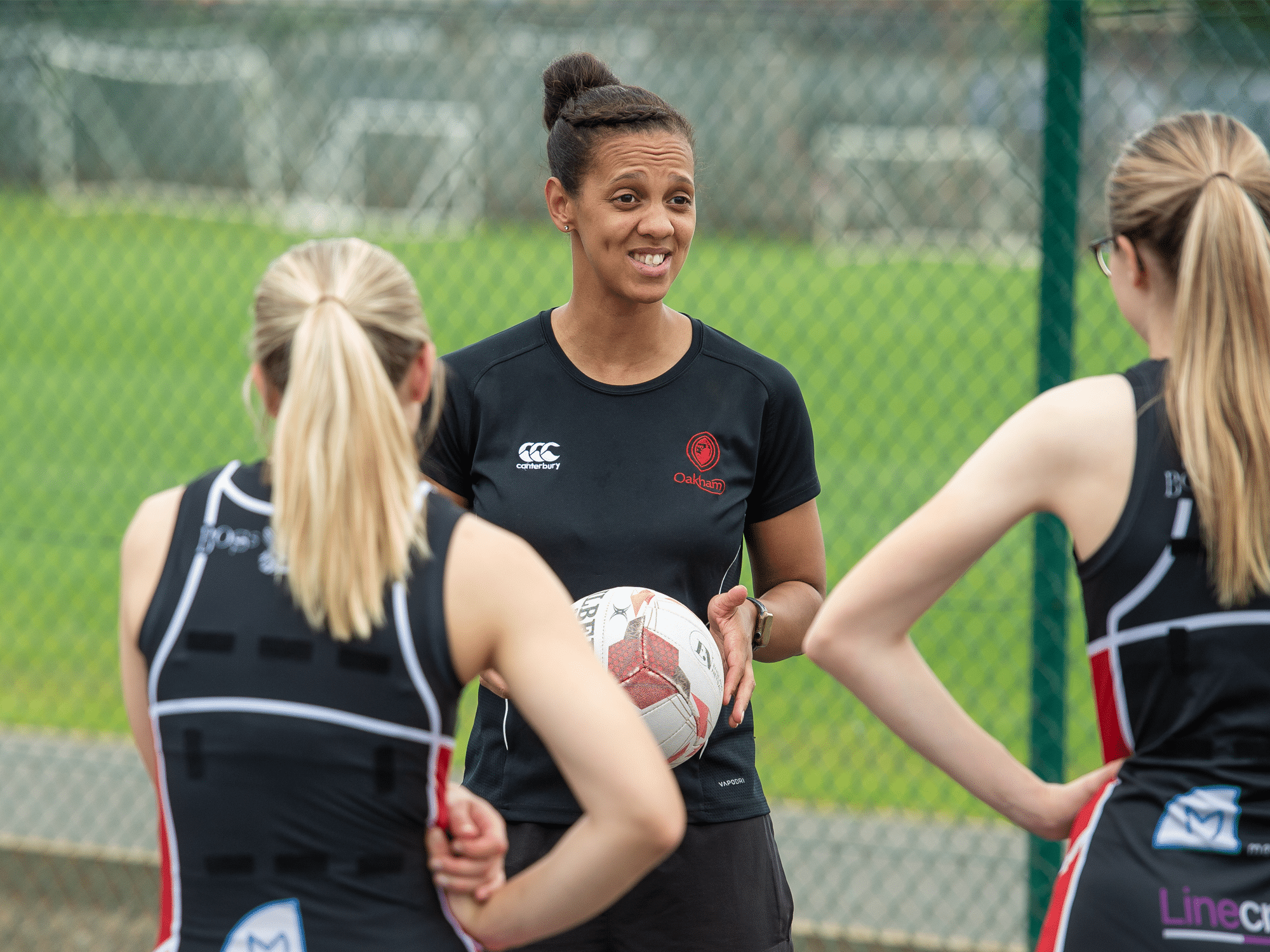 Lauren Nicholls coaching netball at Oakham School