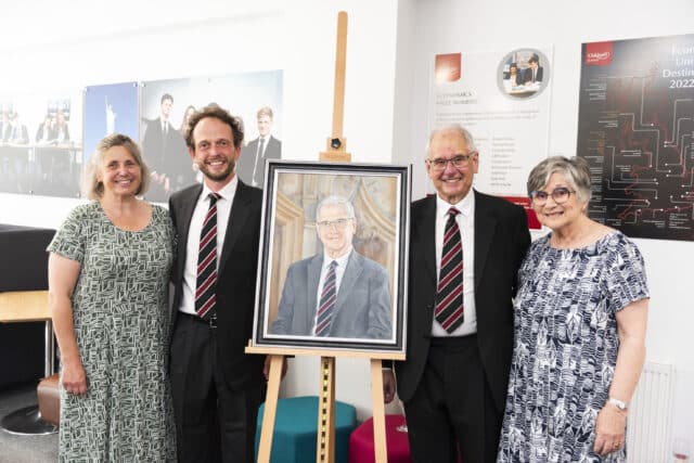 Guests gathered around the portrait with Peter Lawson.